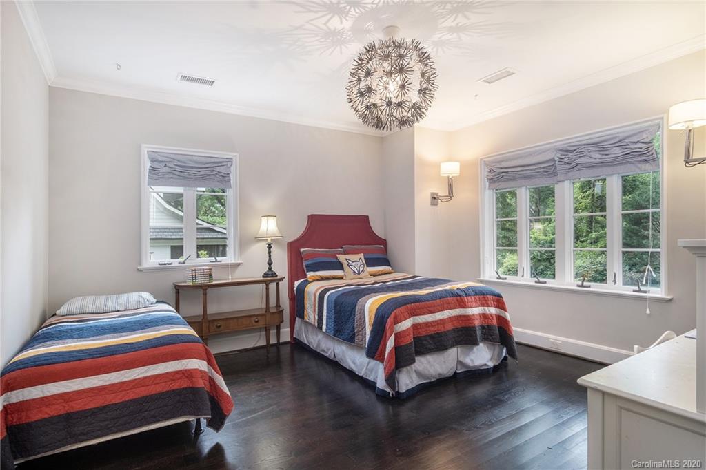 1500 Andover Road Charlotte, NC 28211 - Photo 19 of 24 a bedroom with a bed and a chandelier