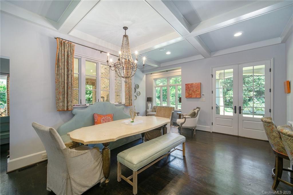 1500 Andover Road Charlotte, NC 28211 - Photo 7 of 24 a outdoor dining room with wooden floor a chandelier a wooden table and chairs