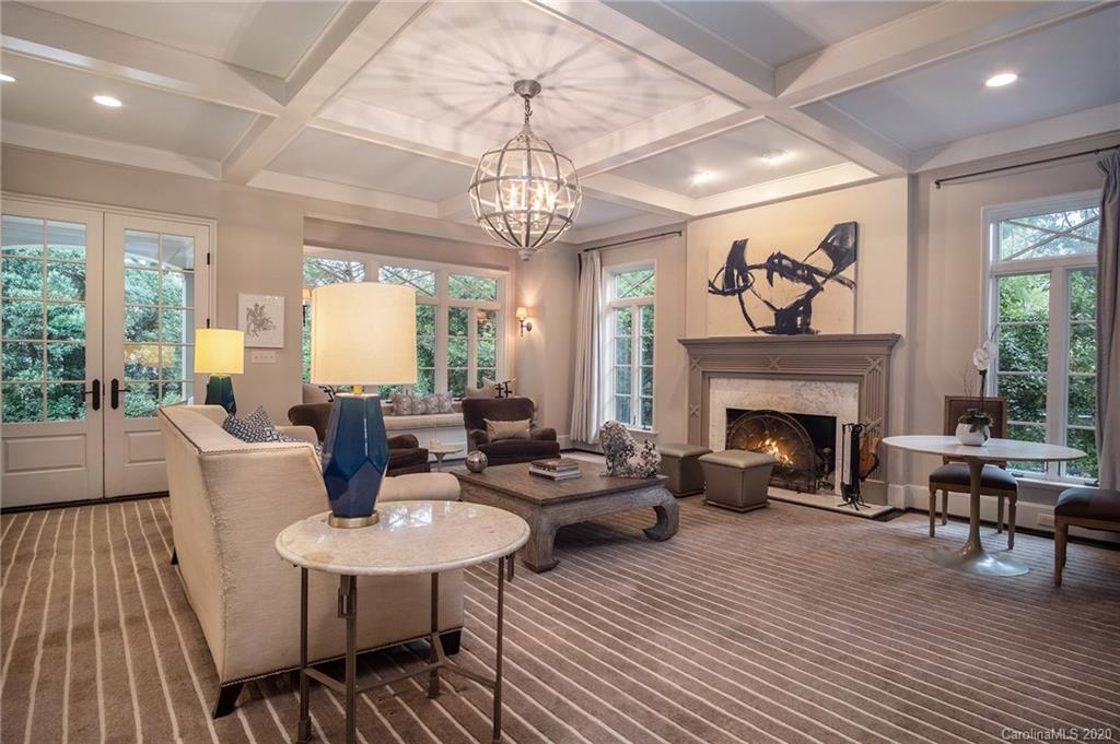 1500 Andover Road Charlotte, NC 28211 - Photo 9 of 24 a living room with furniture a fireplace and a chandelier