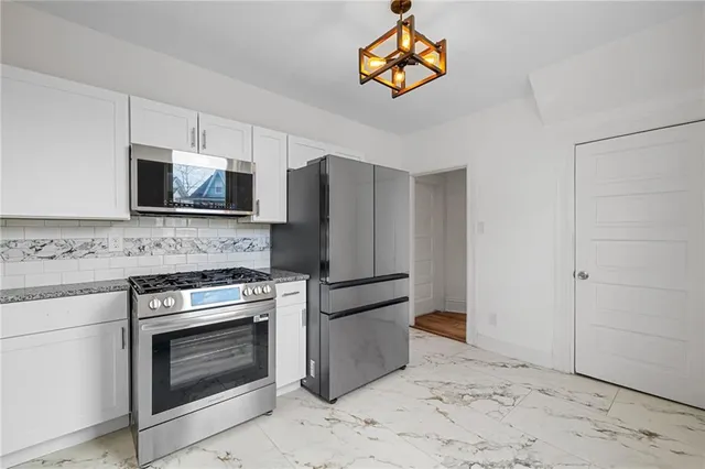 a kitchen with appliances a stove and a microwave