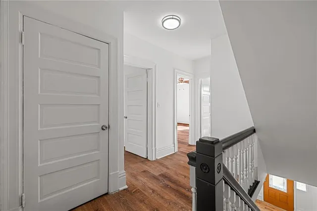 a view of a hallway view with wooden floor and staircase