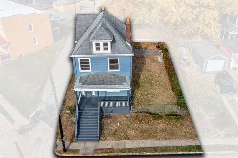 a front view of a house with large windows
