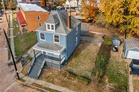 a aerial view of a house with a chairs in a patio