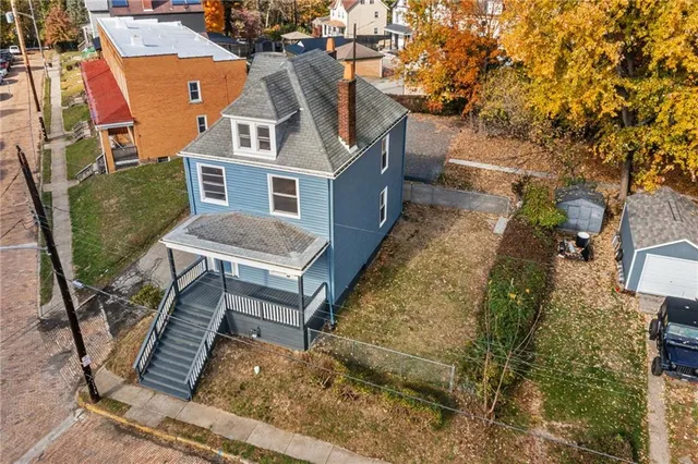 a aerial view of a house with a chairs in a patio