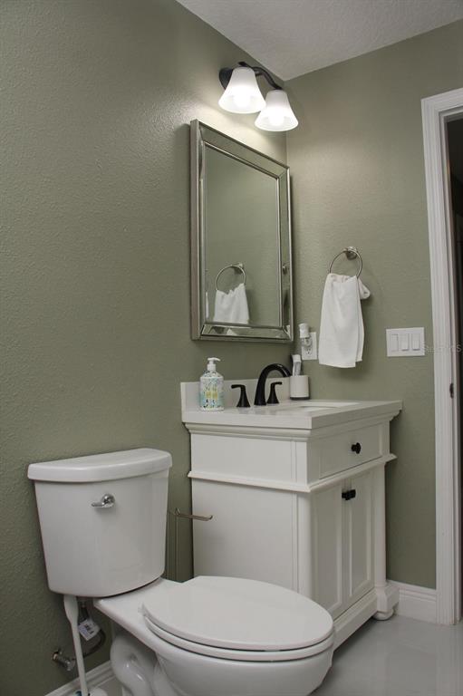 1991 Sanderlin Point Loop Apopka, FL 32703 - Photo 11 of 27 a bathroom with a toilet a sink and mirror