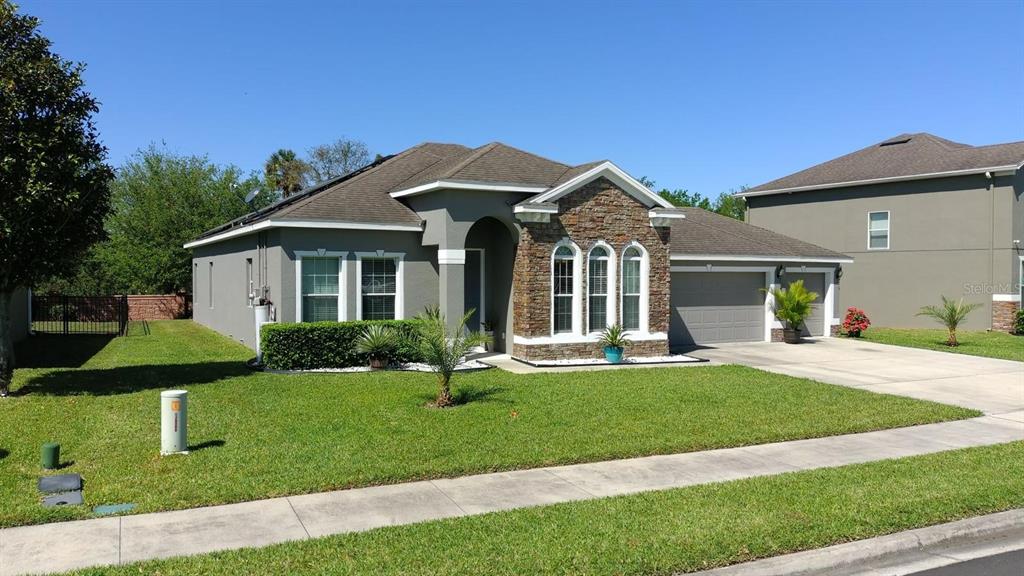 1991 Sanderlin Point Loop Apopka, FL 32703 - Photo 13 of 27 a front view of a house with a yard table and chairs