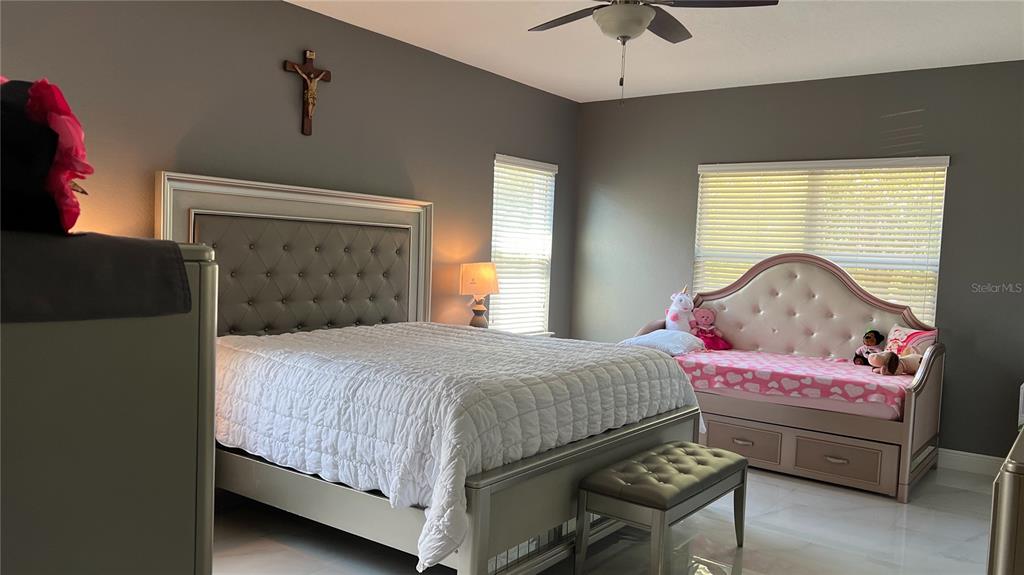 1991 Sanderlin Point Loop Apopka, FL 32703 - Photo 22 of 27 a bedroom with a bed and a window