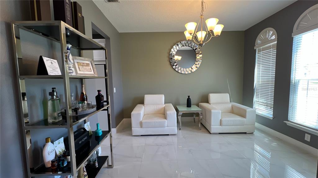 1991 Sanderlin Point Loop Apopka, FL 32703 - Photo 26 of 27 a living room with patio couch and a large window