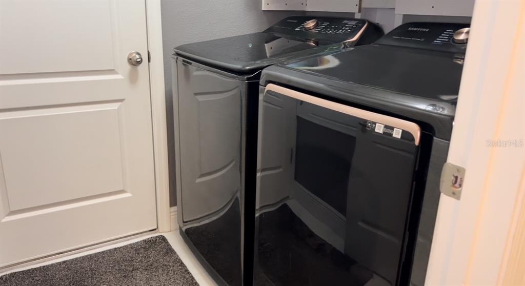 1991 Sanderlin Point Loop Apopka, FL 32703 - Photo 27 of 27 a utility room with dryer and washer