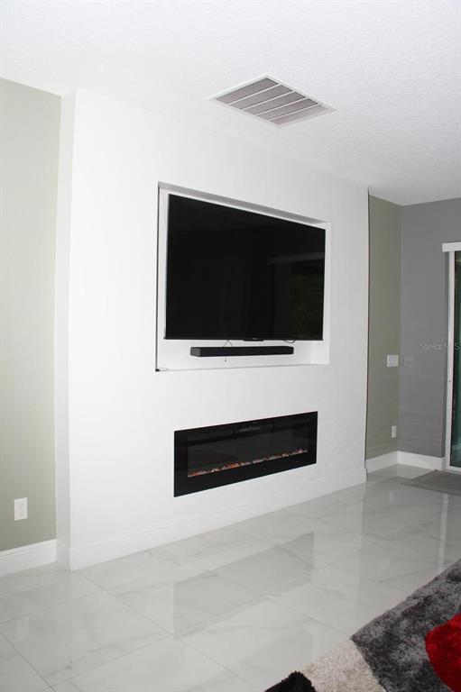 1991 Sanderlin Point Loop Apopka, FL 32703 - Photo 5 of 27 a living room with a flat screen tv