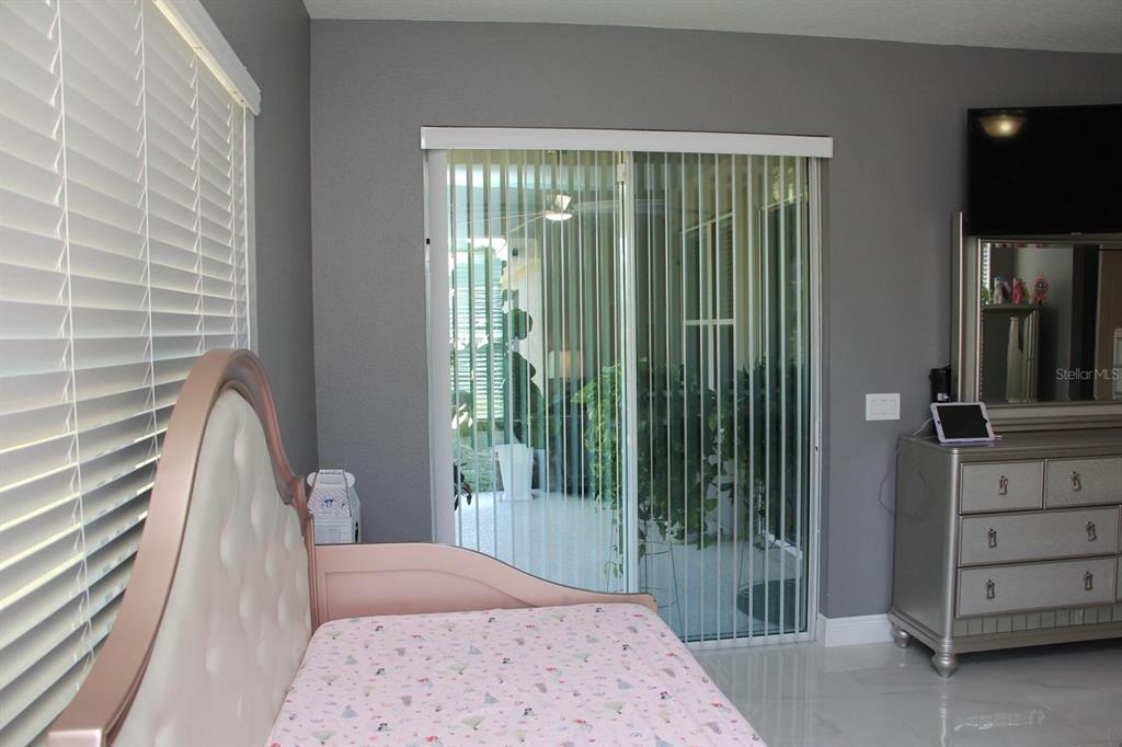 1991 Sanderlin Point Loop Apopka, FL 32703 - Photo 7 of 27 a bedroom with a bed and a television