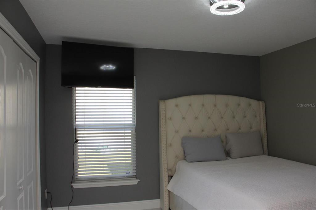 1991 Sanderlin Point Loop Apopka, FL 32703 - Photo 10 of 27 a bed sitting in a bedroom next to a window