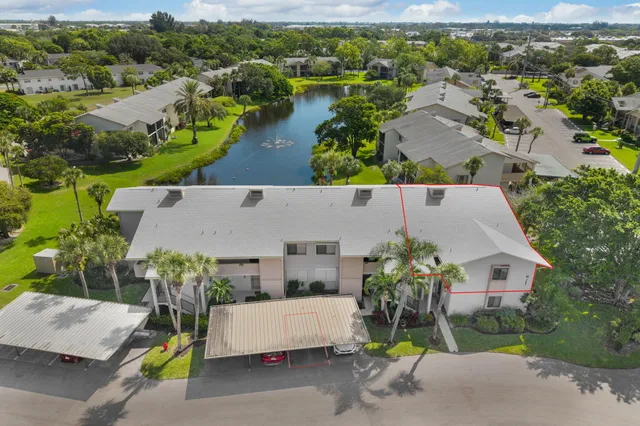 an aerial view of a house with swimming pool and couple of houses
