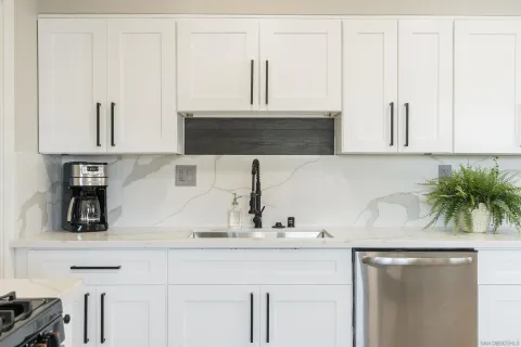 a kitchen with a sink and cabinets