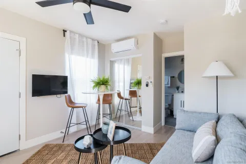 a view of a livingroom with furniture and a flat screen tv