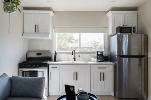 a kitchen with appliances a sink and a window