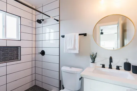 a bathroom with a sink toilet and shower