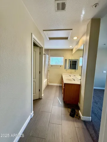 a large bathroom with a sink a toilet a mirror and vanity