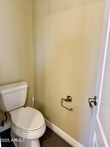 a white toilet sitting next to a shower