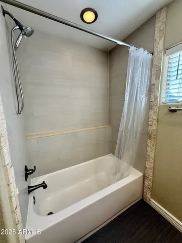 a bathroom with a tub and a shower