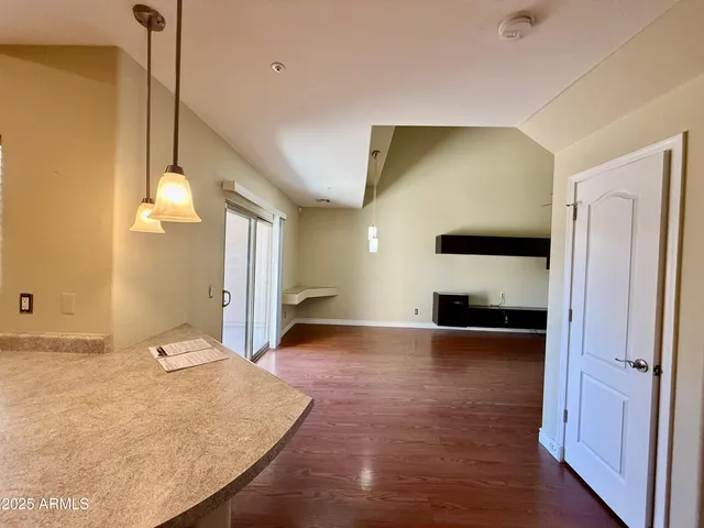 a view of a room with wooden floor