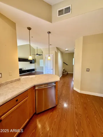 a view of a kitchen with a sink and wooden floor