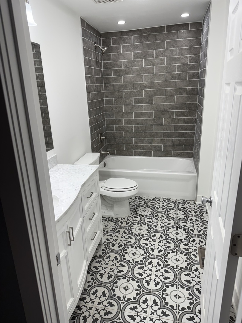 13621 Homan Avenue Robbins, IL 60472 - Photo 12 of 25 a bathroom with a sink a toilet and shower