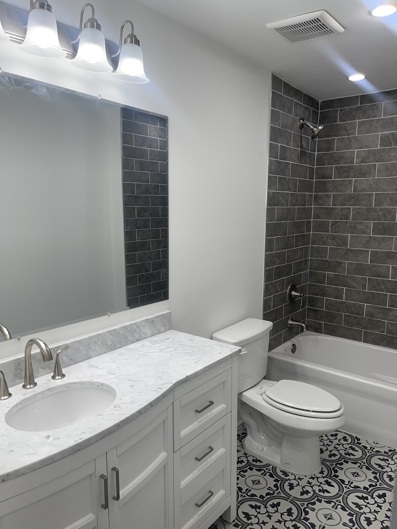 13621 Homan Avenue Robbins, IL 60472 - Photo 13 of 25 a bathroom with a sink a toilet and shower