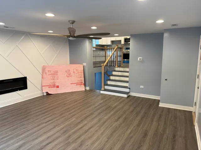 an empty room with wooden floor and entryway