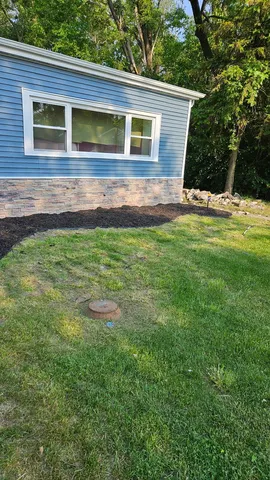 a view of a house with a yard