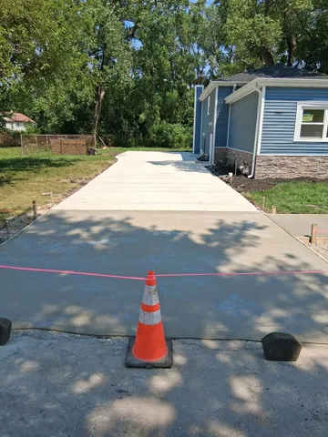 a backyard of a house with barbeque oven table and chairs