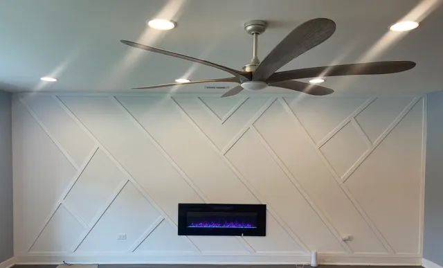 a view of a hallway with a ceiling fan and wooden floor