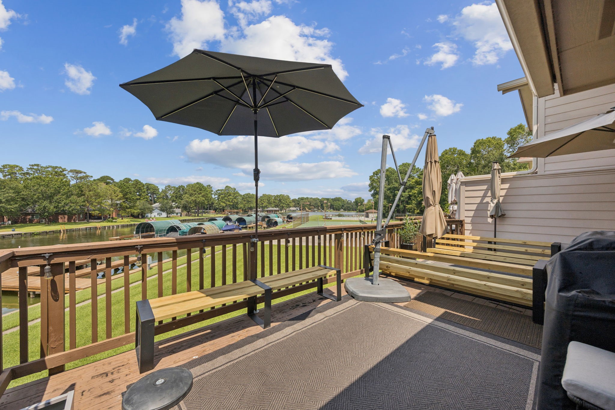 500 River Road, Unit 106 Montgomery, TX 77356 - Photo 3 of 32 Enjoy serene waterfront living from your private deck with stunning views of the water.