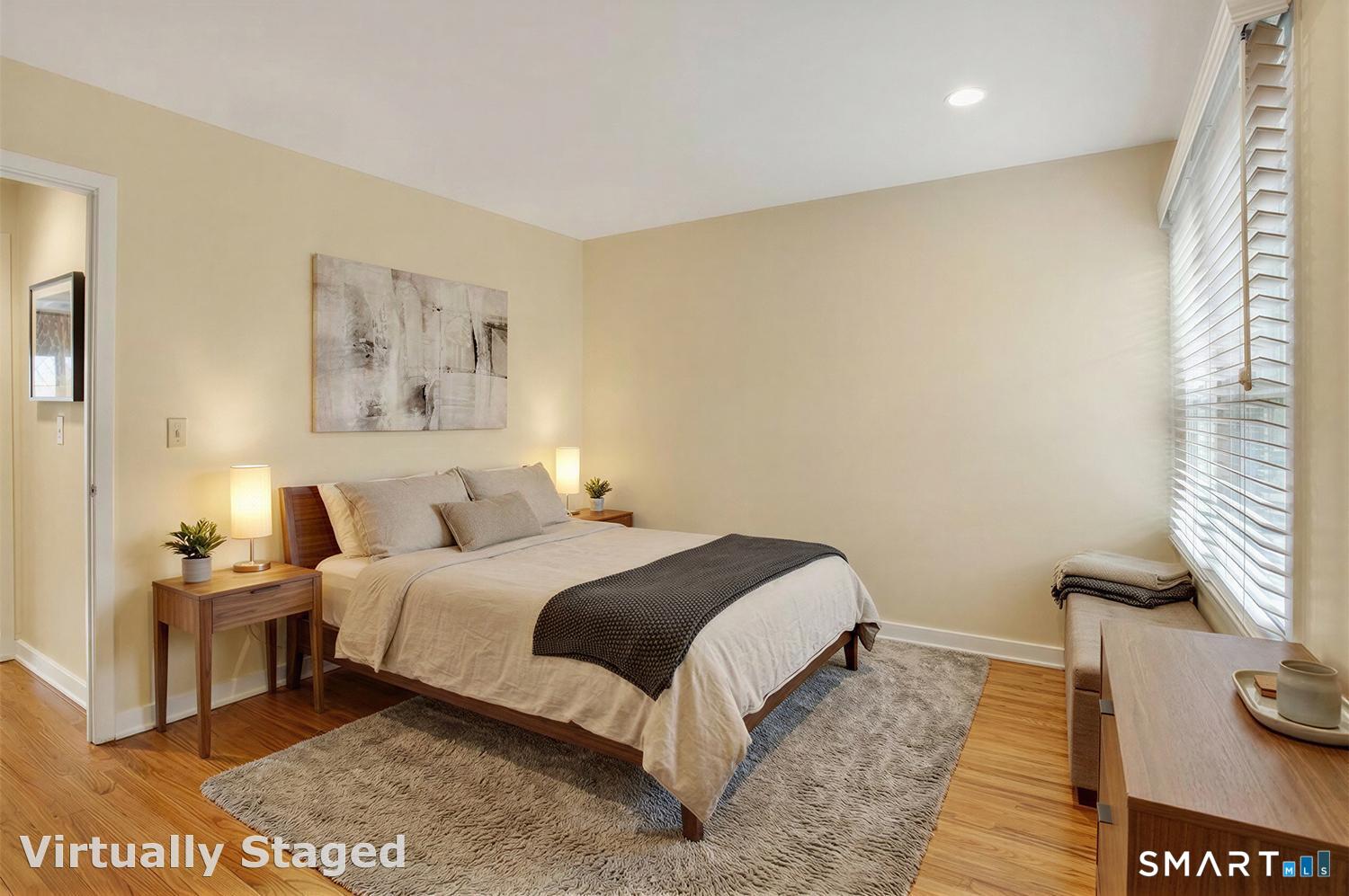 23 Balmaha Cl Fairfield, CT 06825 - Photo 19 of 29 a bedroom with a bed and a painting on the wall