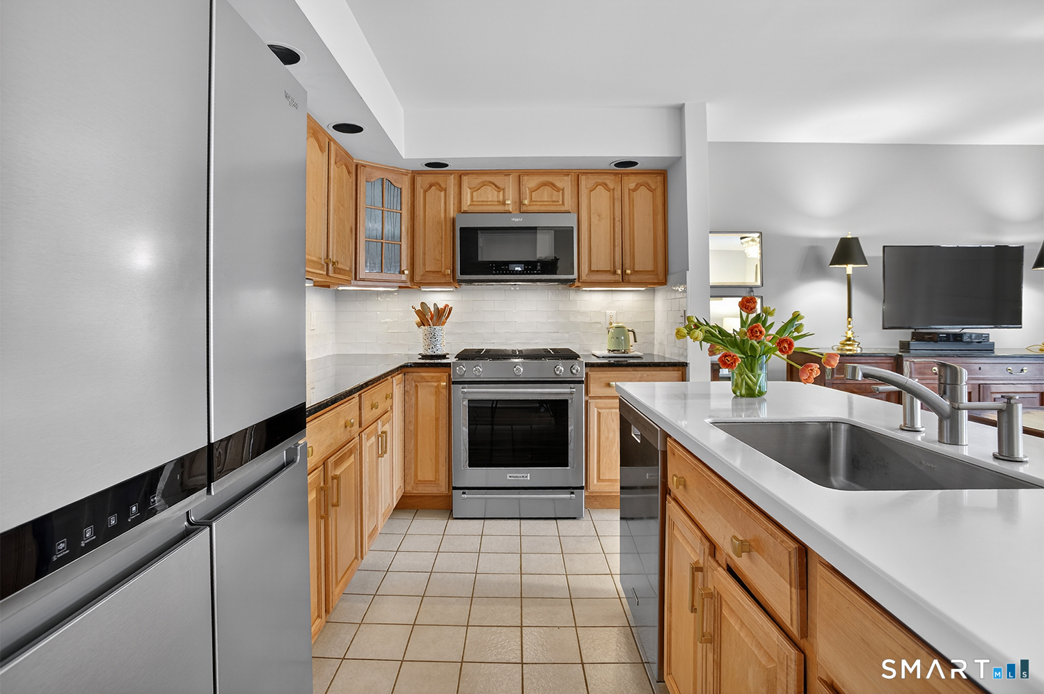 23 Balmaha Cl Fairfield, CT 06825 - Photo 9 of 29 a kitchen with granite countertop a stove a sink and a microwave