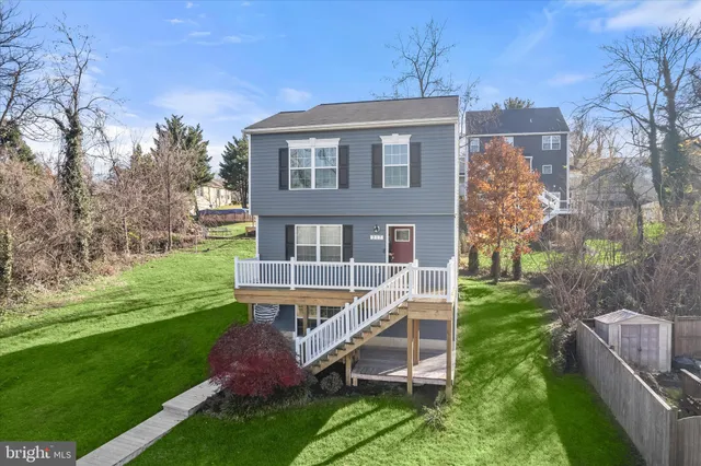 a view of a house with a yard and sitting area