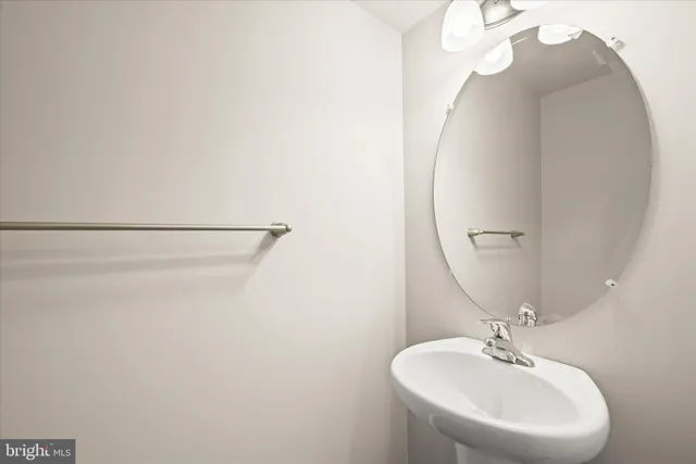 a bathroom with a sink a mirror and vanity