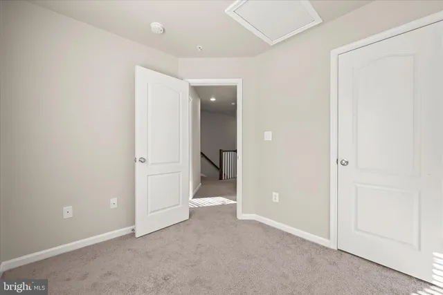 an empty room with closet and a bathroom