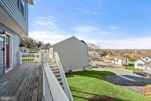 a view of a yard with plants and wooden fence