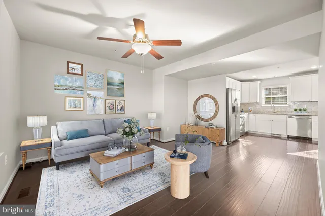 a living room with furniture a rug and a window