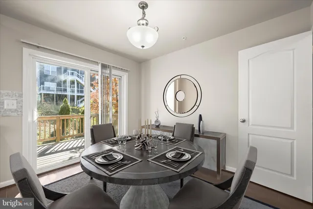 a living room with furniture a window and wooden floor