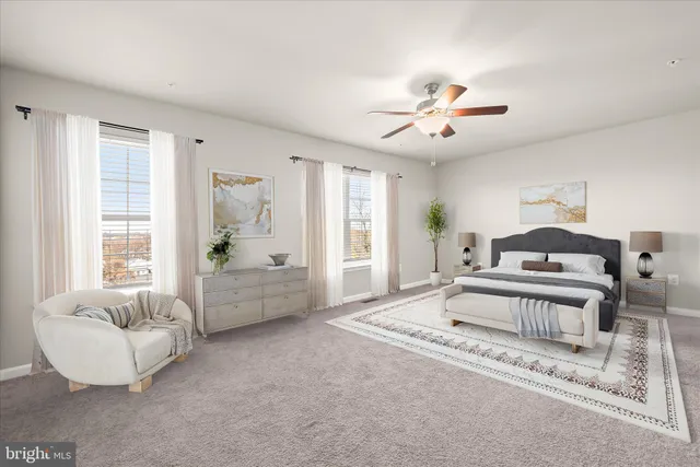 a spacious bedroom with a balcony a bed and a couch