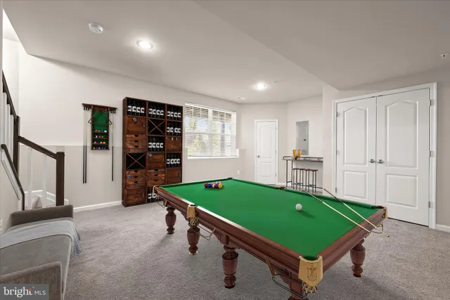a room with pool table and windows