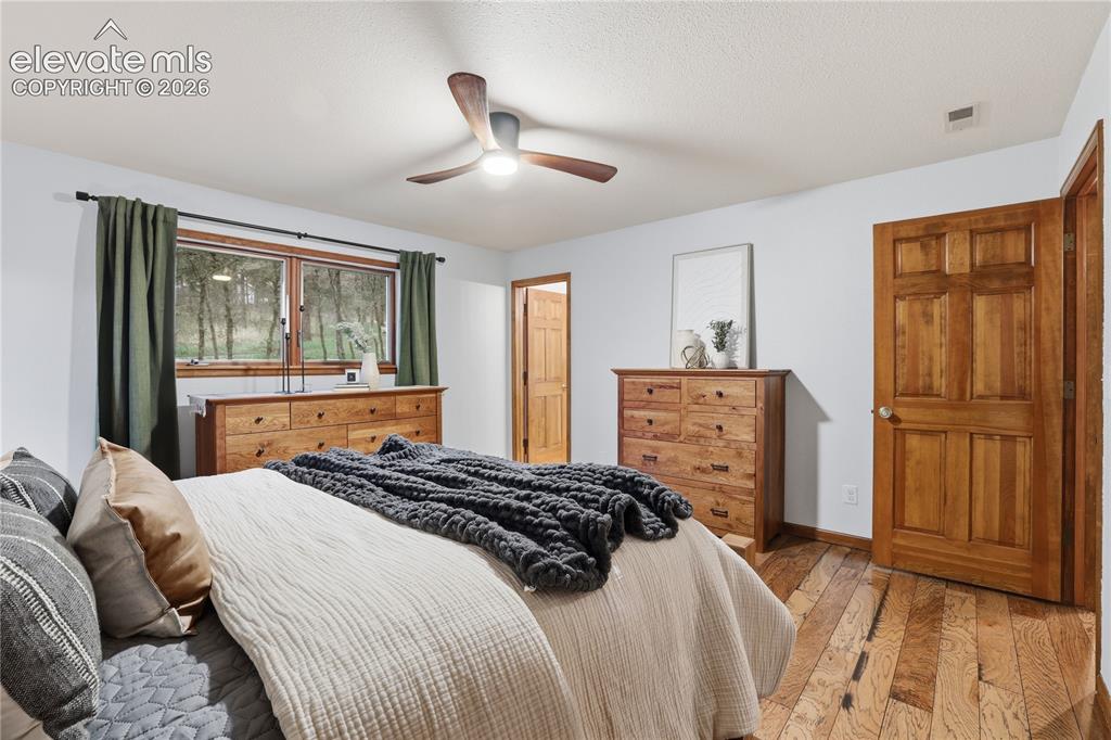 18190 Forest View Road Monument, CO 80132 - Photo 21 of 50 a bedroom with a bed and a dresser