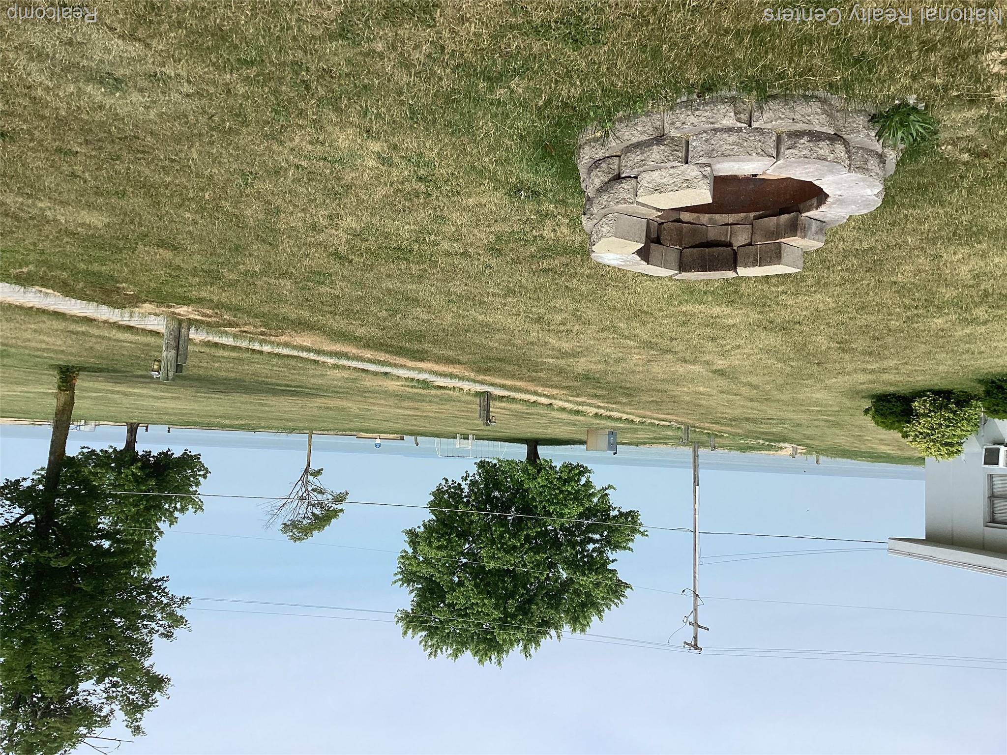 6024 Port Austin Road, Unit 5 Caseville, MI 48725 - Photo 29 of 56 Custom fire pit created 3 years ago with view of gorgeous sunsets at night