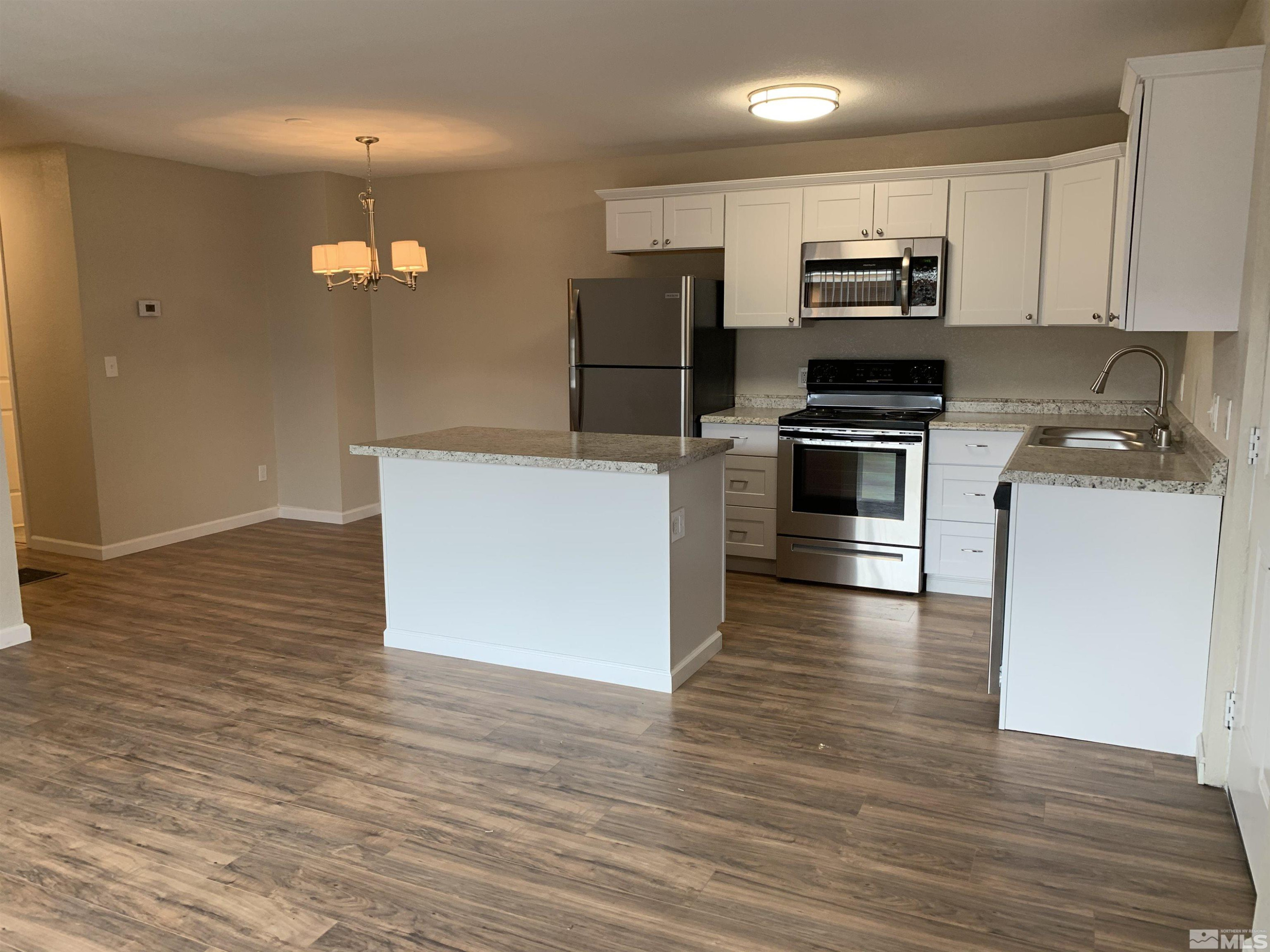 a kitchen with wooden cabinets and stainless steel appliances