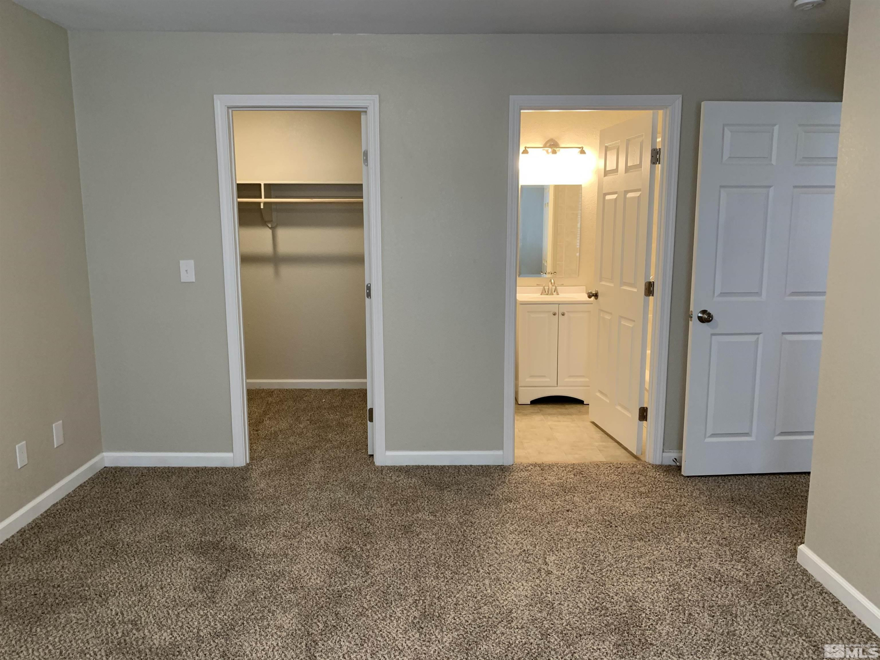 2150 Sutro Street, Unit A3 Reno, NV 89512 - Photo 7 of 8 an empty room with closet and windows