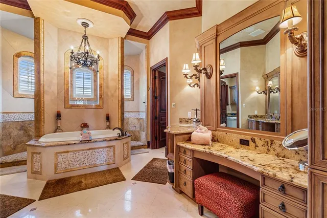 a bedroom with a large bed and a chandelier