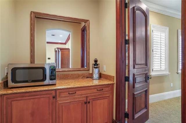 a view of a house with swimming pool and sitting area