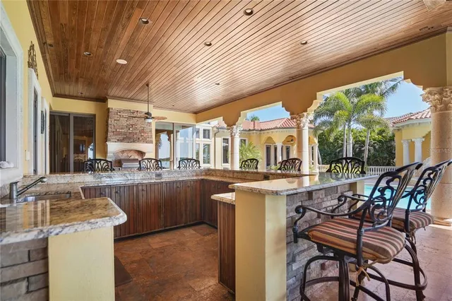 a front view of house with swimming pool and porch with furniture